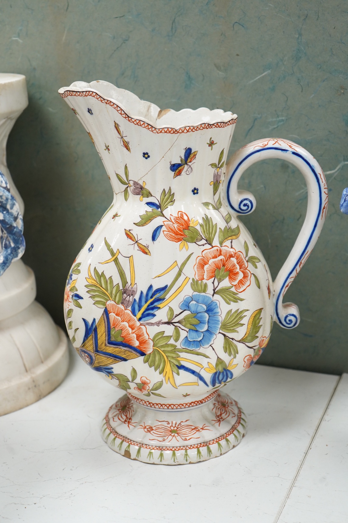 Two large French faience jugs and a vase, and a Talavera twin handled urn/vase, 44cm high